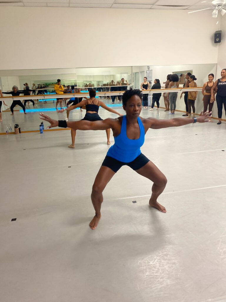 Modern dance class in Dallas, TX Woman practicing modern dance in an adult dance class in Dallas with other modern dance students